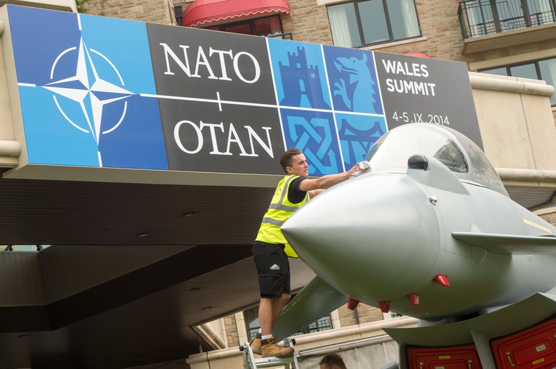 epa04382182 Employees clean a Eurofighter Typhoon in front of the Celtic Manor Resort in Newport, south Wales, 03 September 2014. World leaders from about 60 countries are coming together for a two-day NATO summit taking place at the Celtic Manor Resort, Newport, south Wales, from 04-05 September 2014.  EPA/MAURIZIO GAMBARINI